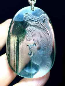 Natural green ghost phoenix pendant. The crystal is clear and the color is emerald green. The phoenix is regarded as the king of all birds and is a symbol of good luck happiness peace prosperity and flourishing.