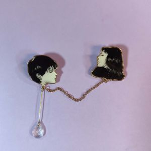 This elegant enamel pin is inspired by Tomie from Junji Itos works. With fine craftsmanship it showcases Tomies charm.
