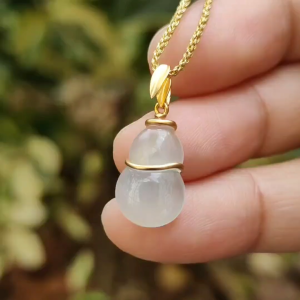 Crafted as Gourd Pendant on Natural Type A Jadeite Jade set with 18k Gold certificate weighs 1.17 grams measurement 14.5 * 9.4 * 3.5 mm (18kp79)