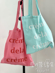 กระเป๋าผ้าใบลายตัวอักษรสไตล์เกาหลีน่ารักสำหรับเดินทางแบบบาง กระเป๋าสะพายไหล่ลำลอง กระเป๋าถือสำหรับเดินทางที่ใช้งานได้หลากหลาย กระเป๋าใส่ของ