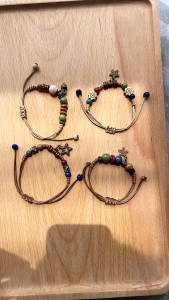Ethnic Style Pine Cone Pendant Bracelet Distressed Pentagram Ceramic Beaded Bracelet Boho Style Beaded Bracelets With Star Charms Adjustable Cord. Colorful Beads Earthy Tones Metal Accents Versatile Accessory. Casual Bohemian Fashion.