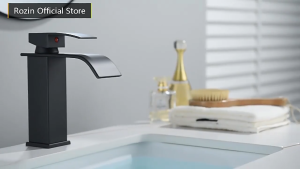 Black modern waterfall faucet with curved spout and single lever handle. Suitable for bathroom or kitchen use.