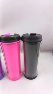 Four colorful travel tumblers with black lids and colored tabs.