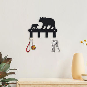The Bear-Shaped Key Chain Is the Key Hanging on the Back Wall of the Garage and the Clothes and Hats Hooked on the Wall