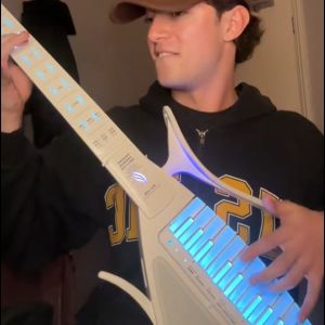 Cyber-G by Enya Stringless Smart Backing GuitarChord GeneratorBuilt-in Drum Machine & Bassline 20 instrument sounds including Electric guitarAcoustic Electric Guitar Digital Piano etc. App Interactive Chord Sheets