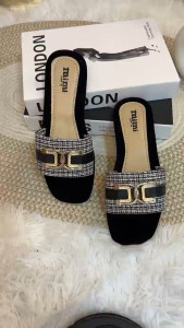 RD616 Black slip-on sandals with woven strap and gold buckle detail.