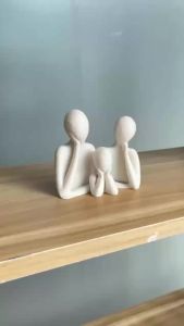 A family decorated wedding statue for three people perfect as an anniversary gift for husband and wife newlyweds or as an art