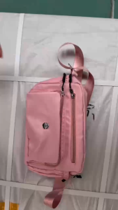 SPSBAGS#4067 Fashionable womens nylon crossbody shoulder bag featuring a distinctive circular logo on a front-pouch compartment
