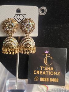 Gold Jhumka Earrings with White Stones and Dangling Details