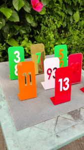 Gold number 7 sign orange number 11 sign white number 9 sign red number 13 sign pink number 90 sign outdoor display stand