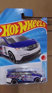 Hot Wheels Honda Odyssey minivan toy car with number 93 and cartoon character design in blue and white packaging.