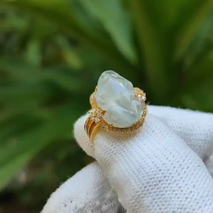 Highly Translucent Icy Variety Natural Type A Jadeite with NGI Gemstone report 18k Gold Jadeite Ring with Diamonds carved as pixiu weighs 5.01 grams 15.23 * 11.57 * 5.60 mm Internal Diameter Finger size = 15.2mm (18kring11)