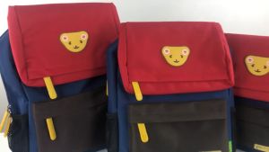 เสื้อผ้าผ่านชั้นประถมศึกษา สำหรับเด็กชาย และเด็กหญิง รูปหน้าเป้าหมาย ใหม่ใหม่ กระเป๋าเป้หัวหมีน่ารัก ความจุข ขนาดใหญ่หลายขนาด