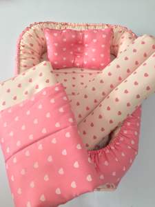 Oval nest with headpillow bolsters and comforter