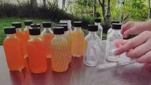 12 pieces of glass bottles with LIDS and 3 funnels well sealed and easy to carry