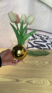 Gold-plated flower vase with sunflowers three spherical vases reflective surface decorative home decor modern minimalist setting.