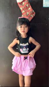 Black Kuromi tank top with pink ruffled skirt and bow.