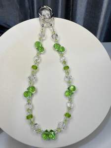 Colorful beaded phone strap with apple-shaped charms and clear beads.