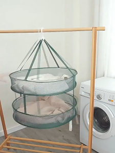 Green hanging mesh shoe organizer with two tiers for storage and drying.