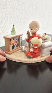 Precious Moments boy & girl in pajamas watching Rudolph the red-nosed reindeer on tv