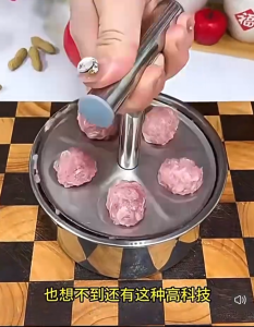 Stainless steel meatball maker with handle for making five balls at a time.