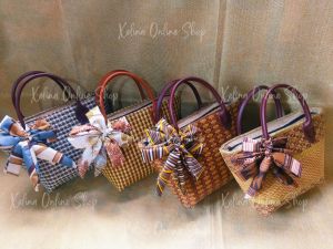 Handbags with bows and handles in various patterns and colors.