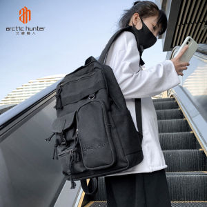 ARCTIC HUNTER กระเป๋าเป้สะพายหลังผู้ชายกระเป๋านักเรียนชายและหญิงสไตล์ฮ่องกงกระเป๋าเป้สะพายหลังแฟชั่นแนวสตรีทเท่ๆกระเป๋าเป้สะพายหลังความจุใหญ่แบบลําลอง