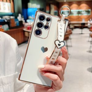 CrashStar เคสโทรศัพท์เคสนิ่มเคลือบอิเล็คโทรเพลทสายรัดข้อมือสุดหรูลายหัวใจเคสโทรศัพท์กันกระแทกสำหรับ Samsung Galaxy S25 S24 S23พิเศษ + S21 S22บวก S20 FE A55 A35 A15 A54 A14 A53 A33 A13 5G เคสโทรศัพท์แฟชั่น A16 A56พร้อมขาตั้งสายรัดข้อมือ