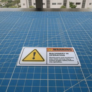 Machinery in Operation. Safety Sticker. Warning Caution Danger Sign Label. Triangle Exclamation Mark. Factory Machine.