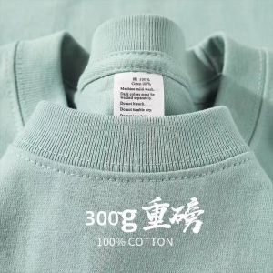 เสื้อยืดคอกลมแขนสั้นทรงหลวมสำหรับผู้ชายและผู้หญิง ผ้าฝ้ายเนื้อหนา 300 กรัม สีขาวบริสุทธิ์ ลำลอง ใส่สบาย ฤดูร้อน 2025