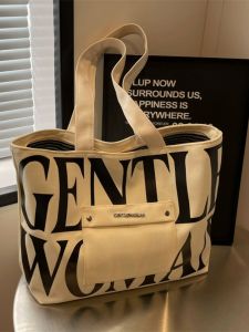 กระเป๋าผ้าใบลายตัวอักษรแฟชั่นสำหรับผู้หญิง กระเป๋าถือลำลองความจุขนาดใหญ่ กระเป๋าสะพายไหล่สำหรับนักเรียนมัธยมปลาย กระเป๋าสะพายข้างสำหรับเดินทาง