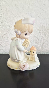 Precious Moments growing in grace age 7 girl dressed as a nurse feeding syrup to an ill cat