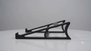 Laptop stand with curved legs and angled design for ergonomic use in modern workspace 3D printed