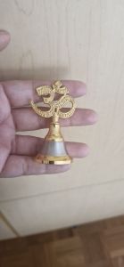 Gold Pooja Ghanti Bell with decorative handle and silver base for Hindu worship rituals.