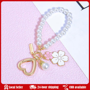 Sweet Pink Sakura Flower Key Ring Pearl Chain Wristband Keychain With Metal Tag Women Girl Callphone Car Handbag Ornaments Lovely Cherry Blossoms Fan Keychain Pearl Chain Letter Pendant Women Car Key Ring Headphone Case Charms Bag Decor Accessories