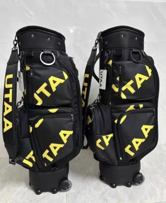 Túi đựng gậy golf UTAA màu đen với chữ vàng nhiều ngăn có bánh xe và quai đeo phù hợp cho chơi golf ngoài trời.