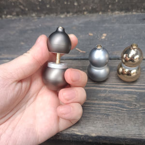 This metal gourd-shaped fidget spinner features magnetic buttons and a slider making it easy to carry and stress-relieving.