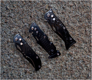 Vintage black folding knives with silver screws and textured handles on textured surface mini fruits knife camping hiking tool