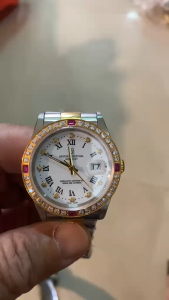 Oyster Perpetual Datejust Superlative Chronometer Crown King Automatic MEN watchES with diamond ruby bezel Roman numeral hour markers date window at 3 oclock gold and silver case.