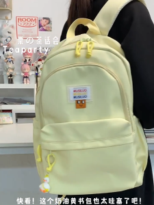 MOUSSON กระเป๋าเป้สะพายหลังสำหรับเด็กกระเป๋าเป้สะพายหลังสีเหลืองนมเหนียวนุ่มสำหรับเด็กนักเรียนง่ายและอเนกประสงค์ฉบับภาษาเกาหลี