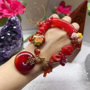 Red Beaded Bracelet with Charm and Pendant Features Floral Design and Cross Motif