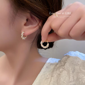 Elegant circle pearl earrings with silver hoop design. Perfect for adding sophistication to any outfit.