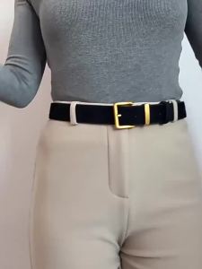 Retro-style suede leather belt with simple button closure design. Womens formal suit accessory.