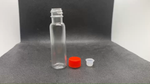 ขวด 24 มล. ( 100 ใบ) พลาสติกกลมPVCสีใส+ จุกตัน + ฝาแดง ( GW.= 0.84 Kg. ) 05#18