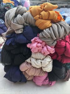 Colorful fabric bundles for doormats and pot holders 10kg per bundle assorted colors including gray orange pink red black and beige.