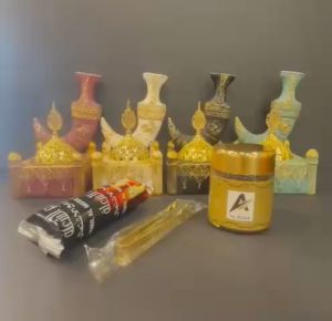 Arabian traditional ceramic burner set is designed for the aromatic practice of burning bakhoor. The set features a beautifully crafted ceramic burner with intricate gold and black designs making it a decorative and functional piece.