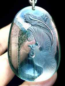 Natural green ghost phoenix pendant with clear crystals and a lush green color symbolizing happiness peace prosperity and flourishing.