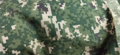 Kain army camouflage fabric with pixelated pattern in green beige and black. Suitable for military or outdoor use. Ideal for making uniforms or gear.1meter long 1meter width