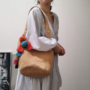 DaVee Handmade woven Raffia bucket bag beige straw bag with colorful tassels for casual outings.