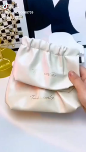 Serenity drawstring pouches in black cream pink and brown with cosmetic products.
